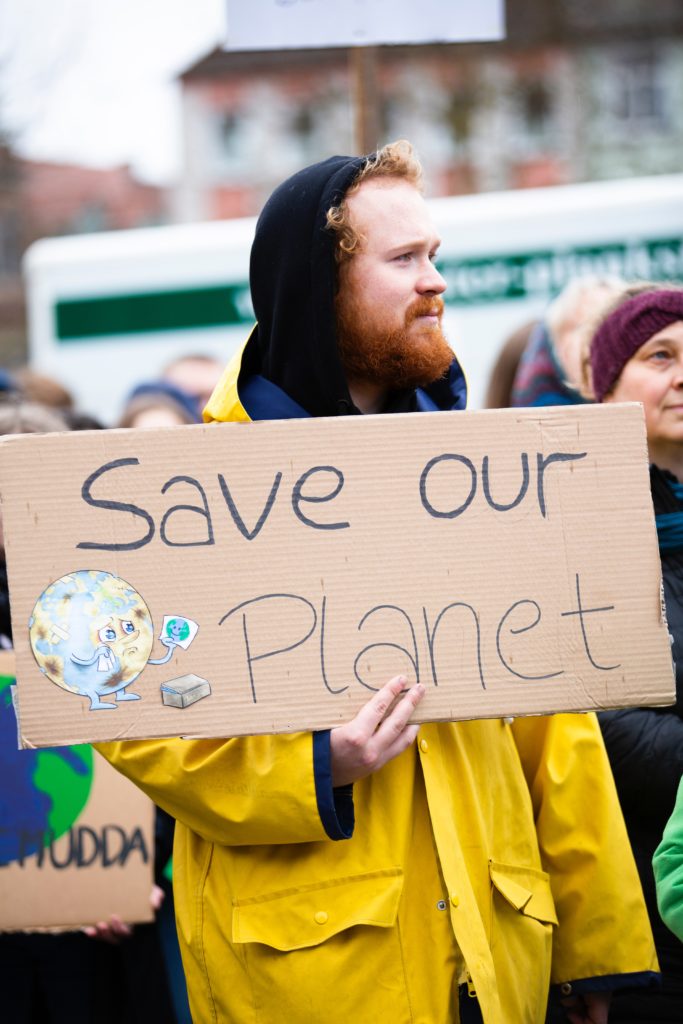 A person holding Save our Planet Sign